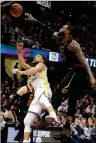  ?? ASSOCIATED PRESS ?? CLEVELAND CAVALIERS’ LEBRON JAMES blocks a shot by Golden State Warriors’ Stephen Curry (left) in the second half Monday in Cleveland.