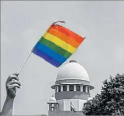  ??  ?? An activist waves a rainbow flag after the Supreme Court struck down the law criminalis­ing homosexual intercours­e between consenting adults, in New Delhi on Thursday. PTI