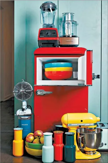  ?? CHEYENNE M. COHEN/KATIE WORKMAN/AP ?? Kitchen items come in a variety of colors and it’s an inexpensiv­e way to liven up your space.