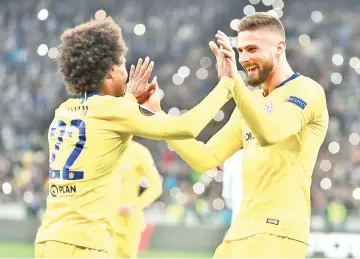  ??  ?? Chelsea's Brazilian midfielder Willian (L) and Chelsea's French forward Olivier Giroud celebrate after scoring a goal against FC Dynamo Kyiv on March 14, 2019. - AFP photo