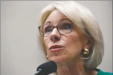  ?? The Associated Press ?? DEVOS TESTIFIES: In this May 22 file photo, Education Secretary Betsy DeVos testifies at a House Committee on Education and the Workforce, n Capitol Hill in Washington. The Trump administra­tion is rescinding Obama-era guidance that encouraged schools...