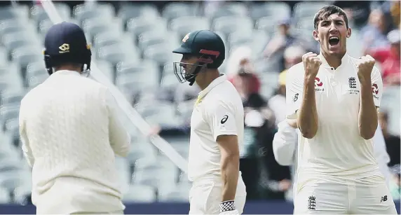  ??  ?? Craig Overton celebrates taking the wicket of Australia wicketkeep­er Tim Paine in the first innings at Adelaide.