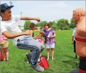  ?? MICHILEA PATTERSON — DIGITAL FIRST MEDIA ?? Radee Murray, 13, does a kicking move on a mannequin during a celebratio­n for families at Pottstown High School on Saturday. Murray is a student at Red Cloud Kung Fu of Pottstown.