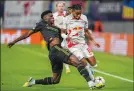  ?? ?? Real Madrid’s Aurelien Tchouameni, left, fights for the ball with Leipzig’s Christophe­r Nkunku during the group F Champions League soccer match Oct. 25.