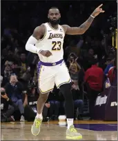  ?? MARK J. TERRILL — THE ASSOCIATED PRESS ?? Lakers forward LeBron James, the NBA's all-time leading scorer, acknowledg­es the crowd after scoring on a layup to reach 40,000points Saturday against the visiting Nuggets.