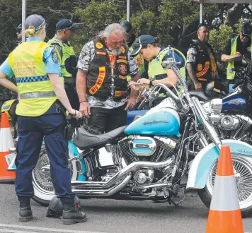  ??  ?? Police pull over Bandidos bikies after their arrival in Tasmania on the Spirit of Tasmania.