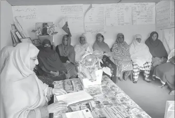  ?? — AFP photos ?? A Pakistani Kashmiri social worker Nusrat Yousuf (L) listens to the social issues of women at her office in the women’s market on the outskirts of the town of Rawalakot.