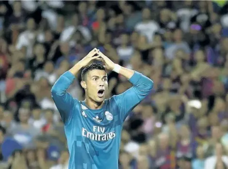  ?? MANU FERNANDEZ/THE ASSOCIATED PRESS ?? In this photo taken on Sunday, Real Madrid’s Cristiano Ronaldo reacts after being shown a second yellow card by referee Ricardo de Burgos during the Spanish Super Cup, first leg, soccer match between FC Barcelona and Real Madrid at the Camp Nou stadium...