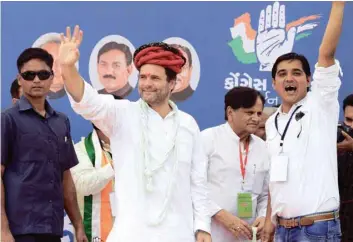  ?? — AFP ?? Congress Vice-President Rahul Gandhi waves to supporters upon arriving at Khatraj village, some 35 km from Ahmedabad, on Monday.