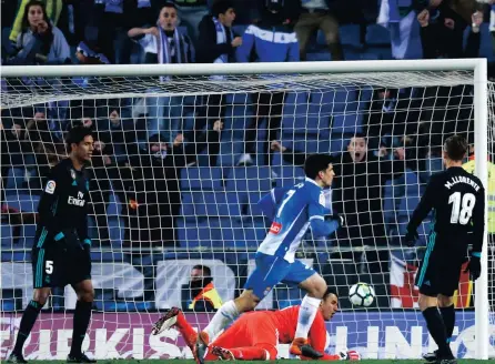  ?? PICTURE: AP ?? KICKER: Espanyol Gerard Moreno, center, scores against Real Madrid´s goalkeeper Diego Lopez during the Spanish La Liga soccer match between Espanyol and Real Madrid at RCDE stadium in Cornella Llobregat, Spain, Tuesday, Feb. 27, 2018.