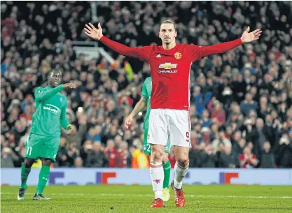  ??  ?? Manchester United’s Zlatan Ibrahimovi­c celebrates after completing his hat-trick against Saint-Etienne.