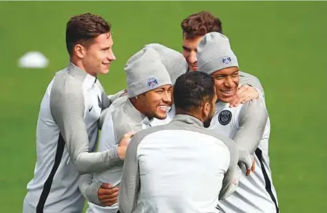  ?? AFP ?? From left: PSG’s Julian Draxler, Neymar and Kylian Mbappe have fun during a training session at the Camp des Loges in Saint-Germain-en-Laye yesterday, on the eve of the Champions League match against Celtic.