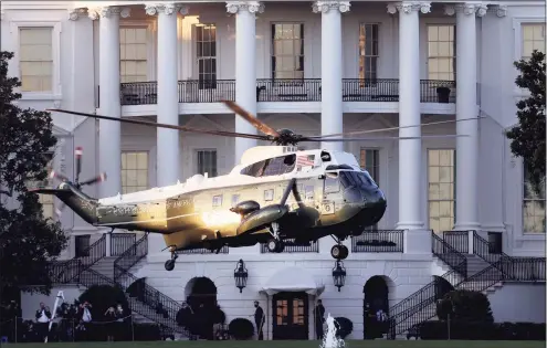  ?? Getty Images ?? Marine One, the presidenti­al helicopter, carries President Donald Trump away from the White House on the way to Walter Reed National Military Medical Center on Oct. 2.