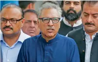  ?? AFP ?? Pakistan Tehreek-i-Insaf candidate Arif Alvi walks back with party leaders after submitting papers for the presidenti­al election outside the high court building in Islamabad on Monday. —