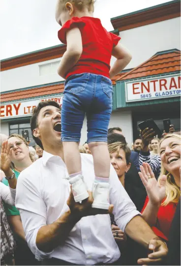  ?? COLE BURSTON / GETTY IMAGES ?? Liberal Leader Justin Trudeau balances a child during a campaign stop
in Niagara Falls, Ont., on Monday.