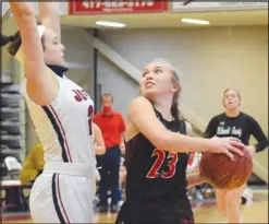  ?? RICK PECK/ SPECIAL TO MCDONALD COUNTY PRESS ?? McDonald County’s Kristin Penn drives around Joplin’s Isabella Yust on her way to the basket during the Lady Mustangs’ 36-34 win on Dec.12 in the fifth place game of the 24th Annual Freeman Lady Eagle Classic.