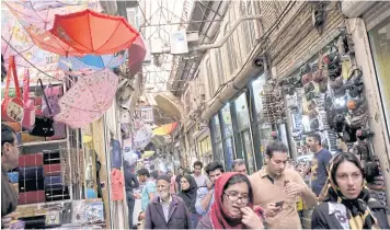  ?? REUTERS ?? People walk through the Grand Bazaar in central Tehran. Bilateral trade between Thailand and Iran is expected to increase after the lifting of sanctions by Western countries.