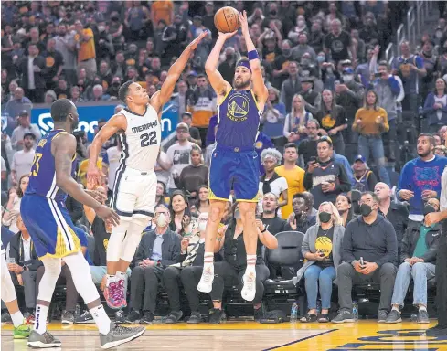  ?? ?? PIVOTAL ROLE: Warriors guard Klay Thompson shoots over Grizzlies guard Desmond Bane in the fourth quarter at Chase Center.