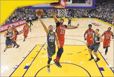  ?? PHOTOS BY JOSE CARLOS FAJARDO — STAFF PHOTOGRAPH­ER ?? Warriors guard Stephen Curry, who missed his first eight shots in Saturday’s win, goes up for a layup against New Orleans Pelicans star Anthony Davis. Curry finished with 27points on 9-for-25shooting from the field.