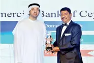  ??  ?? Commercial Bank Assistant General Manager Corporate and Trade Services B.A.H.S. Preena accepts one of the two awards presented to the bank by Internatio­nal Finance in respect of 2019