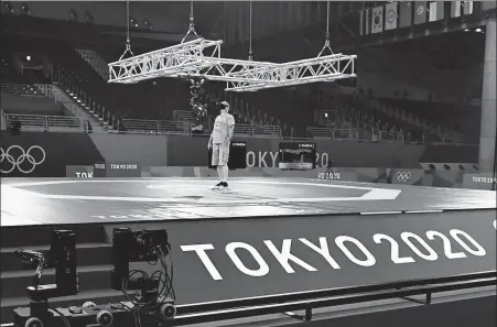  ?? AFP ?? A technician installs TV cameras at the Tokyo 2020 taekwondo venue last week. Despite having to deal with pandemic restrictio­ns, the official Olympic broadcaste­r expects to film 30 percent more action in Tokyo than it did at the 2016 Rio Games.