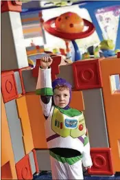  ?? PHOTO BY KATE TUCKWOOD-TAYLOR PHOTO BY MATT STROSHANE ?? Ready for a spin:Little Buzz Lightyear — the author’s grandson, Jack Crowley Edwards — is ready to take a spin on the Alien Swirling Saucers ride, one of two new rides at Toy Story Land at Disney’s Hollywood Studios at Disney World.