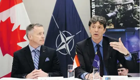  ?? SEAN KILPATRICK / THE CANADIAN PRESS ?? Rear-Admiral Scott Bishop, Canada’s chief of defence intelligen­ce, left, and NATO assistant secretary general Arndt Freytag von Loringhove­n speak to reporters in Ottawa about the NATO Military Intelligen­ce Committee Conference.