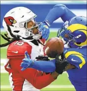  ?? Wally Skalij Los Angeles Times ?? PLAYERS such as Cardinals receiver DeAndre Hopkins, left, and Rams cornerback Jalen Ramsey need to change their attitudes toward the vaccinatio­ns.