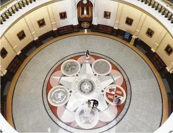  ?? Photos by Kin Man Hui / Staff photograph­er ?? Hamed and Sharmin Riza and their three daughters walk under the rotunda of the Texas Capitol on Monday, the first day the building was open to visitors since the pandemic shuttered it.