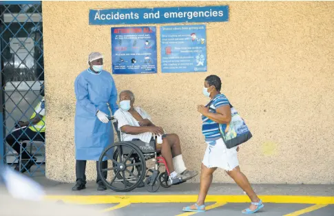  ?? GLADSTONE TAYLOR/MULTIMEDIA PHOTO EDITOR ?? A patient is assisted at Kingston Public Hospital on Thursday. Hundreds of junior doctors across the island staged a sickout over a simmering contracts row, crippling services at many hospitals.