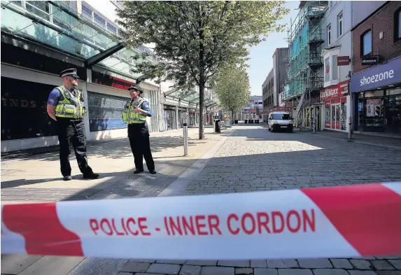  ??  ?? > May 2017: Police at the junction of Union and Oxford Street in Swansea city centre following the bomb hoax