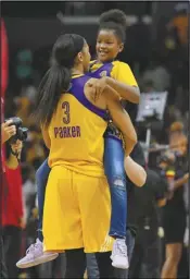  ?? Associated Press ?? FAMILY TIME In this Sept. 29, 2017, file photo, Sparks forward Candace Parker holds her daughter Lailaa Nicole Williams after Game 3 of the WNBA Finals against the Minnesota Lynx in Los Angeles. The Sparks won 75-64. Parker and her 11-yearold daughter are braving the start of an unpreceden­ted WNBA season together in Florida.