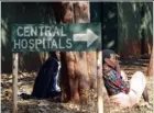  ??  ?? PEOPLE sit just
outside the Parirenyat­wa government hospital in Harare,
Zimbabwe. The advice of doctors to beleagured Zimbabwean­s: Don't get sick. If you do, chronic
shortages of drugs and broken
hospital equipment will probably kill you....