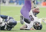  ?? John Froschauer / Associated Press ?? Baltimore QB Lamar Jackson scores a touchdown on a fourth-down keeper play and lands on his head next to Seattle’s Tre Flowers, left, in the Ravens’ 30-16 win on Sunday. Jackson threw for 143 yards and ran for another 116 yards and the one score.