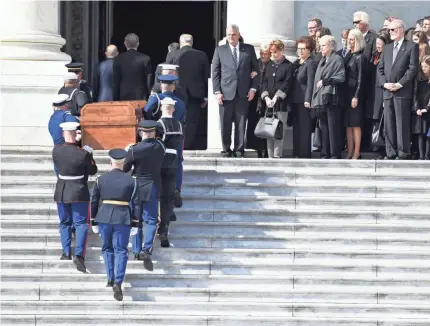  ??  ?? The Graham family watches as the body of evangelist Billy Graham is carried into the U.S. Capitol. JACK GRUBER/USA TODAY