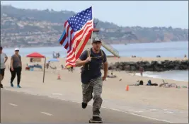  ?? PHOTO BY HOWARD FRESHMAN ?? Army veteran Andrew Goldsmith, shown here in Redondo Beach on Saturday, is training for his upcoming 101-mile skateboard ride along the coast to raise awareness and money for Ukraine.