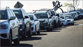  ?? Erik Trautmann / Hearst Connecticu­t Media ?? Cars wait in line for drive-thru and walk-up COVID-19 on Nov. 14 in Norwalk.