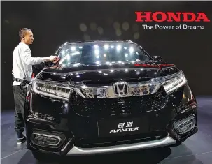  ?? REUTERS ?? A MEMBER of staff cleans Honda Avancier SUV after it was presented during Auto China 2016 auto show in Beijing on April 25, 2016.