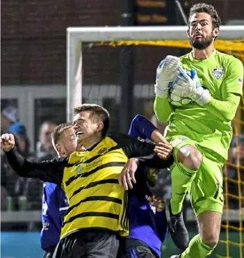  ?? Matt Freed/Post-Gazette ?? Louisville City FC goalkeeper Chris Hubbard makes a save against Mark Forrest in the Riverhound­s’ season-ending playoff loss Nov. 2 at Highmark Stadium.