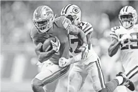  ??  ?? Lions wide receiver Kenny Golladay tries to run past Packers cornerback Josh Jackson after a catch during the first half Oct. 7 at Ford Field.