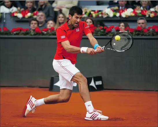  ?? — GETTY IMAGES ?? Novak Djokovic hits a backhand against Andy Murray in the men’s final of the Madrid Open on Sunday.