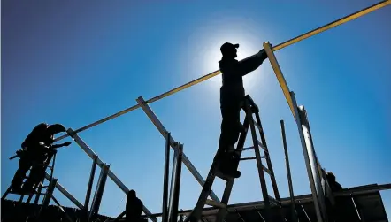  ?? PHOTOS BY JIM WEBER/THE NEW MEXICAN ?? Brandon Bellini with Positive Energy Solar works with a team to install solar panels Wednesday at Casa Milagro south of Santa Fe. A project years in the making, New Energy Economy worked with Casa Milagro to get solar energy for the homeless residence.