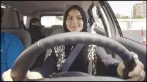  ??  ?? A woman sits in the driver’s seat for the first time during a training sponsored by Ford Motors in Saudi Arabia on Tuesday.