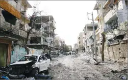  ??  ?? Damaged cars and buildings are seen in the besieged town of Douma, Eastern Ghouta, Damascus, Syria in 2018