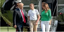  ?? AP ?? President Donald Trump, with first lady Melania Trump and their son Barron, arrives at the White House.