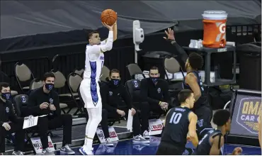  ?? JOHN PETERSON — THE ASSOCIATED PRESS ?? Creighton guard Marcus Zegarowski, left, hits a 3-pointer over the defense of Villanova’s Justin Moore in the first half Saturday. Zegarowski went off for a season-high 25 points in an 86-70 win for the Bluejays.