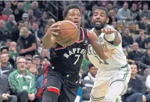  ?? CHRISTOPHE­R EVANS / BOSTON HERALD ?? STILL WITHIN REACH: Kyrie Irving tries to slow down the Raptors’ Kyle Lowry on a drive to the hoop last night at the Garden.