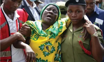  ??  ?? Volunteers assist a civilian at the funeral procession of President John Pombe Magufuli. Photograph: Reuters