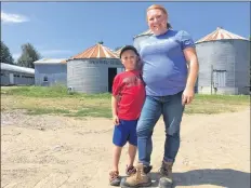  ?? ASHLEY THOMPSON ?? Amy Vanderheid­e loves having her young sons, including Warren, help on the farm.