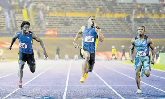  ?? GLADSTONE TAYLOR/MULTIMEDIA PHOTO EDITOR ?? Nigel Ellis (centre) of Elite Track Club wins a heat in the men’s 100 metres at the Gibson McCook Relays on February 24. Gibson McCook Relays held at the National Stadium in St Andrew on Saturday, February 24, 2024.